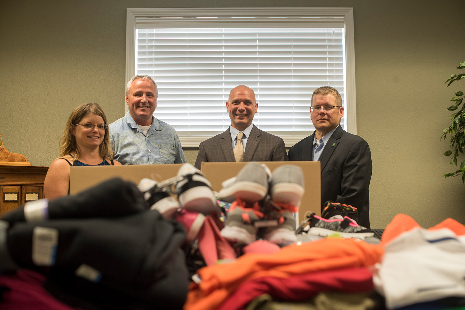 Standing behind $1,000 worth of clothes for school children on Wednesday are, from the left, co-owner of Dick’s Brewery Julie Pendleton, President of the Centralia Community Foundation Dan Rich, Centralia City Councilor Peter Abbarno and Centralia Foundation Secretary Jonathan Meyer. Centralia law firm Althauser Rayan Abbarno partnered with the foundation and Dick’s Brewery to raise funds to purchase the clothes. 