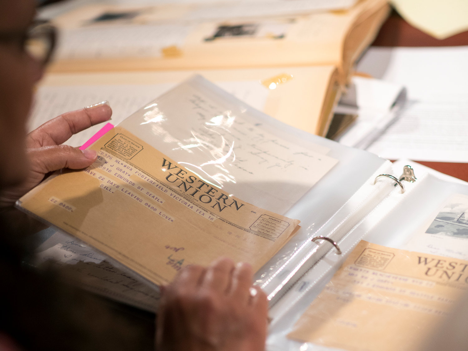 Jan Bradshaw turns the pages of scrapbook that her grandmother collected containing the correspondences she had with her son — Army Air Force 1st Lt. William “Bill” James Gray Jr. — while he served in the military during World War II. 