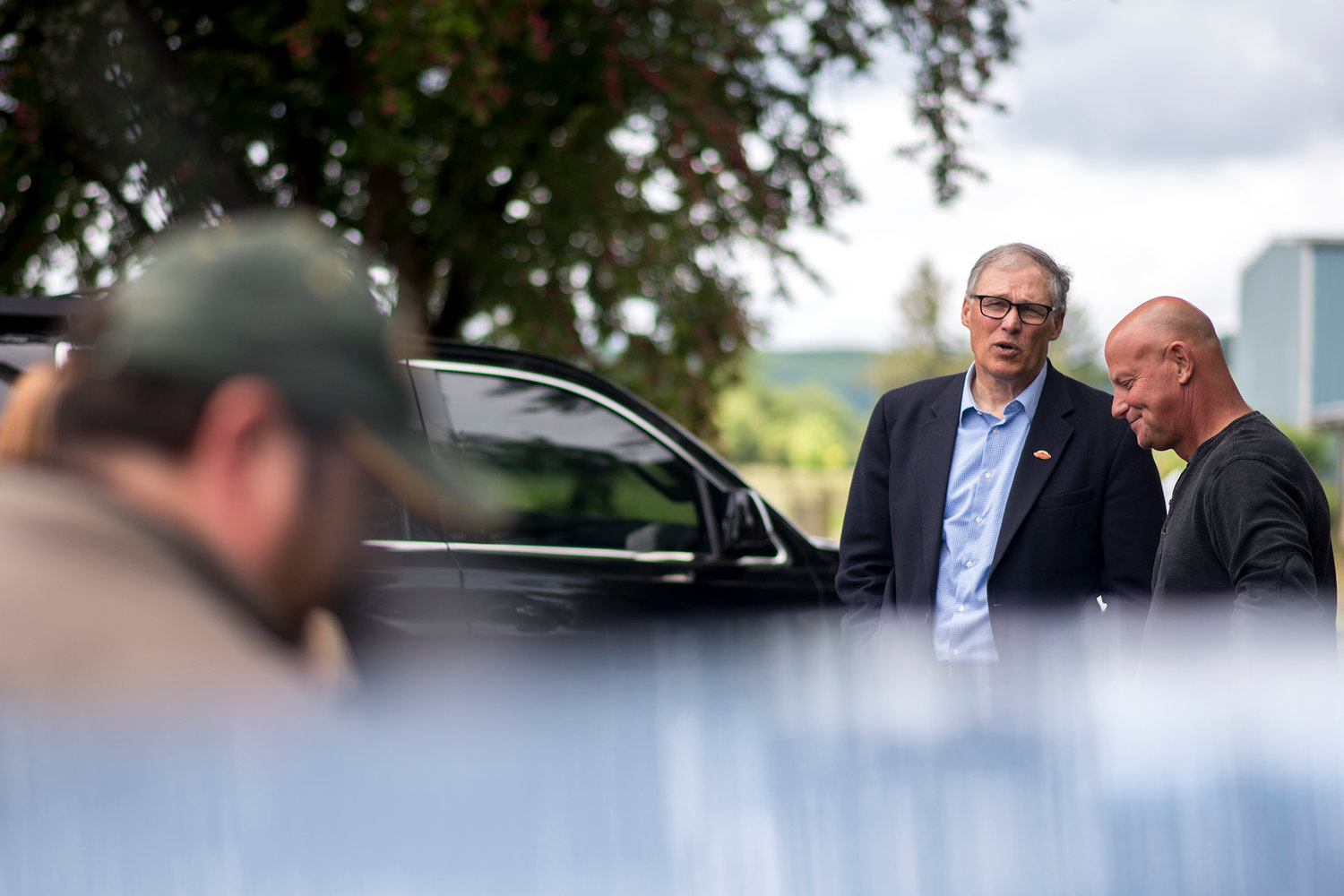 Gov. Jay Inslee, center, speaks with Adna rancher John Brunoff, right, during a June 2017 tour of local areas that have been devastated by past flooding.