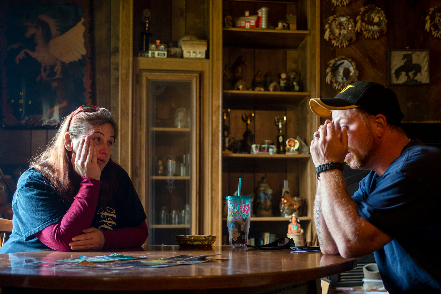 Wendy and Tim Bostwick sit silently at a table covered in pictures of their son Cole Bostwick at Tim's parents house in this Chronicle file photo from Mat 2014. 