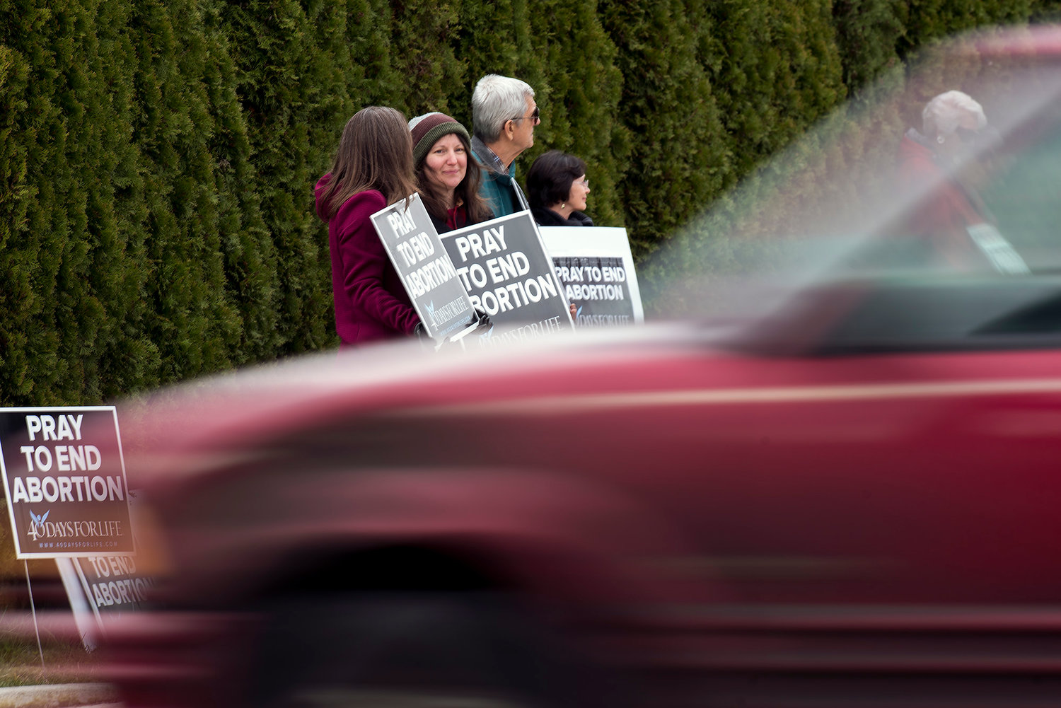 A group of people hold signs and stand outside the Centralia Planned Parenthood on Monday afternoon in association with 40 Days for Life, a pro-life prayer vigil that started on March 1.