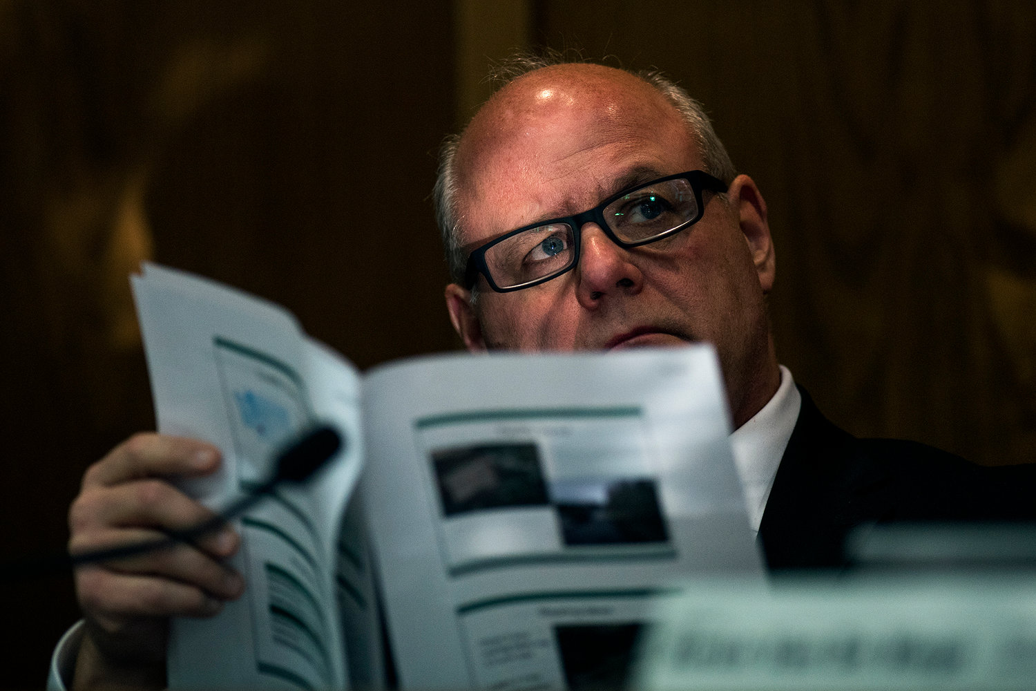 Sen. Kirk Pearson, R-Monroe, chair of the Senate Natural Resources and Parks Committee, looks through a presentation from the Washington Department of Fish and Wildlife concerning the hundreds of thousands of missing fish from the Cowlitz Trout Hatchery during a hearing on Thursday afternoon in Olympia.