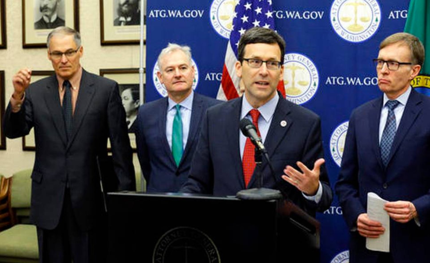 Attorney General Bob Ferguson, second from right, speaks Monday, Jan. 16, 2017, during a news conference at the Capitol in Olympia, Wash. to announce that he and Washington Gov. Jay Inslee, left, have proposed legislation to abolish the death penalty in Washington state.