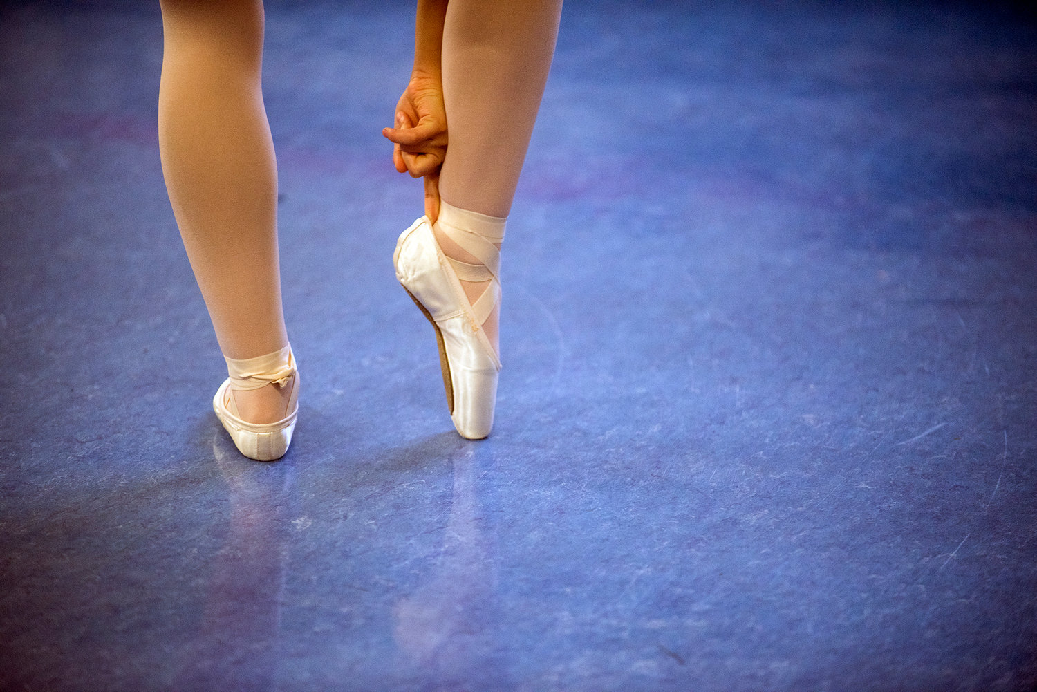A ballerina adjusts her shoe backstage prior to the start of the Nutcracker at Pe Ell High School in December 2016. 