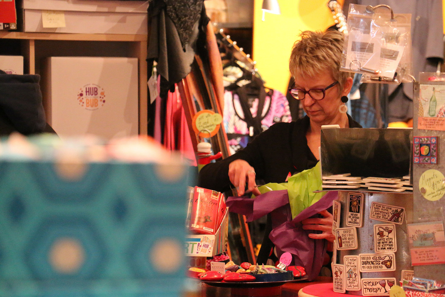 FILE PHOTO — Rebecca Staebler, owner of HUBBUB, wraps a present for a customer.