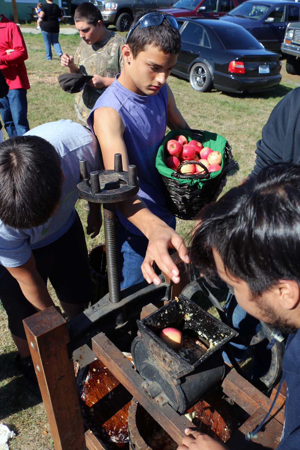 In this Oct. 3, 2015 file photo, members of the Onalaska Football team worked the apple cider press on Saturday at the Apple Harvest Festival in Onalaska. People were able to bring their apples, which were turned into cider through a labor-intensive process on the press.