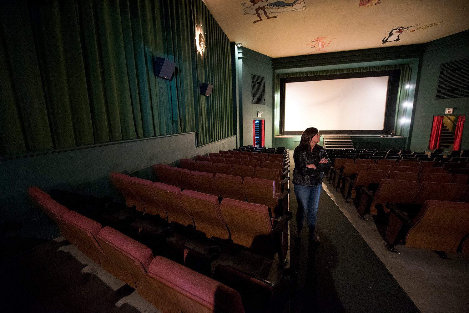 In this May 24 file photo, Debbie Hamilton, who will run the Chehalis Theater, walks up the aisle at theater on in downtown Chehalis. The theater had its soft opening last weekend.