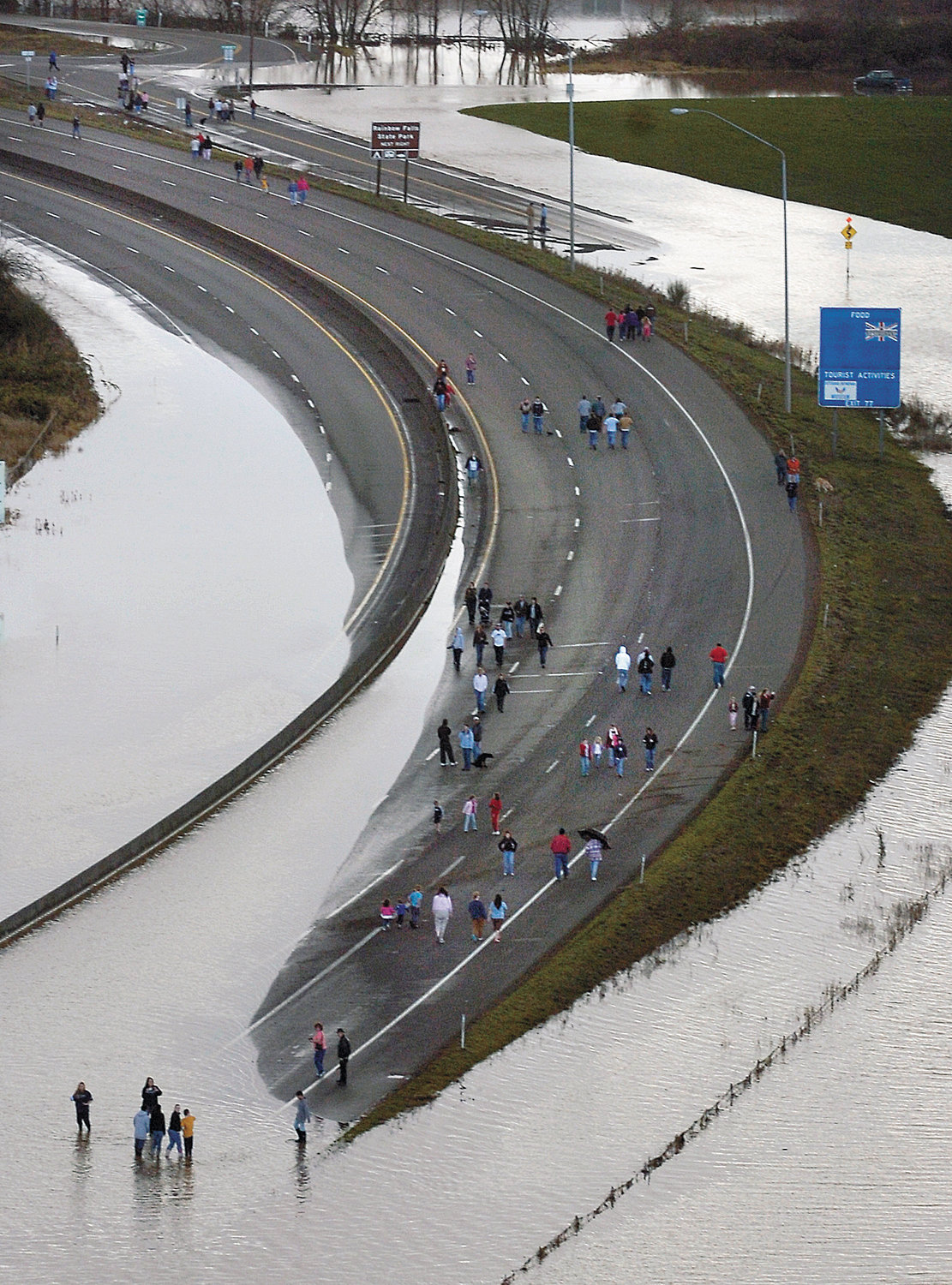People gather on the lanes of flooded Interstate 5 near Chehalis on Tuesday, Dec. 4, 2007 after severe flooding in Lewis County, Washington caused the major north/south freeway to shut down.