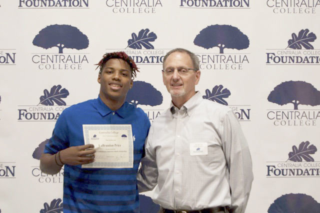 LaBrandon Price accepts the George Gablehouse Endowed Scholarship from Centralia College Athletic Director Bob Peters.
