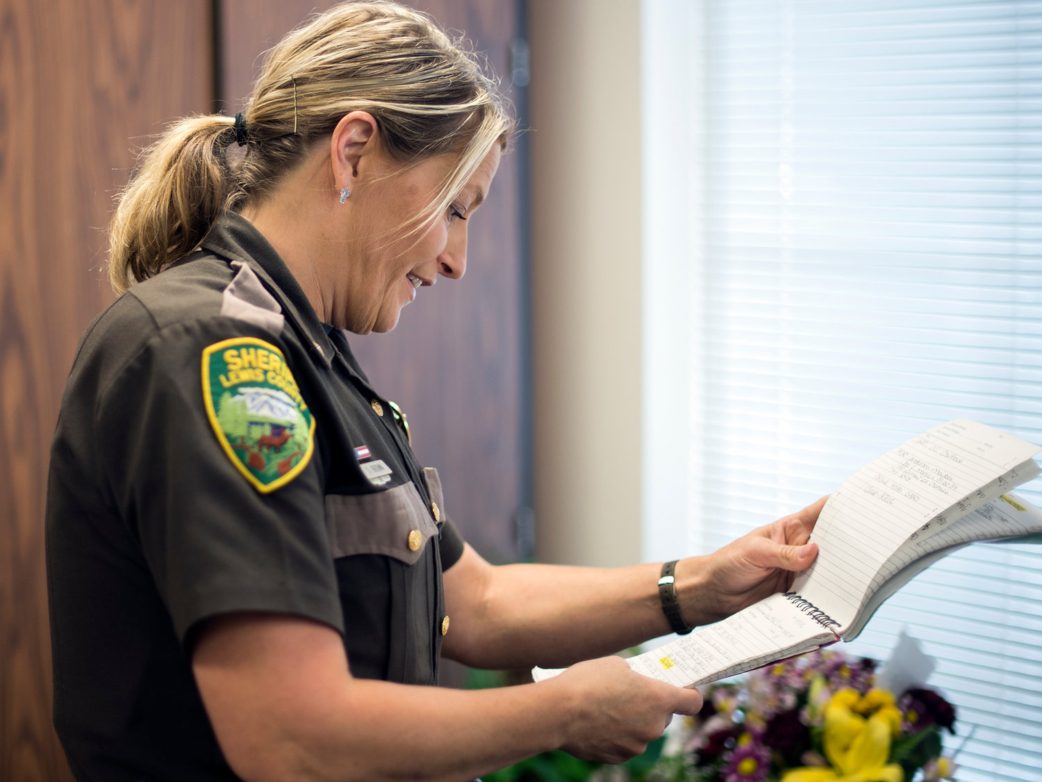 Chief Deputy Stacy Brown looks through her first log book from nearly 20 years ago when she started working at the Lewis County Sheriff's Office on Thursday in Chehalis.