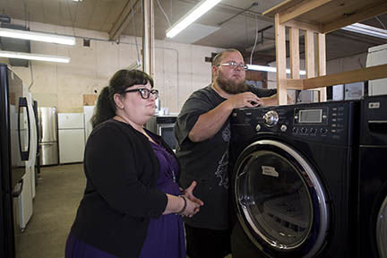 Angie Solis, who owns D.B. Cooper Appliances, and her husband, Donald Byron Cooper, who does a lions share of the maintenance and refurbishing work talk about how they got into the used-appliances business at their downtown Chehalis store on Tuesday afternoon.