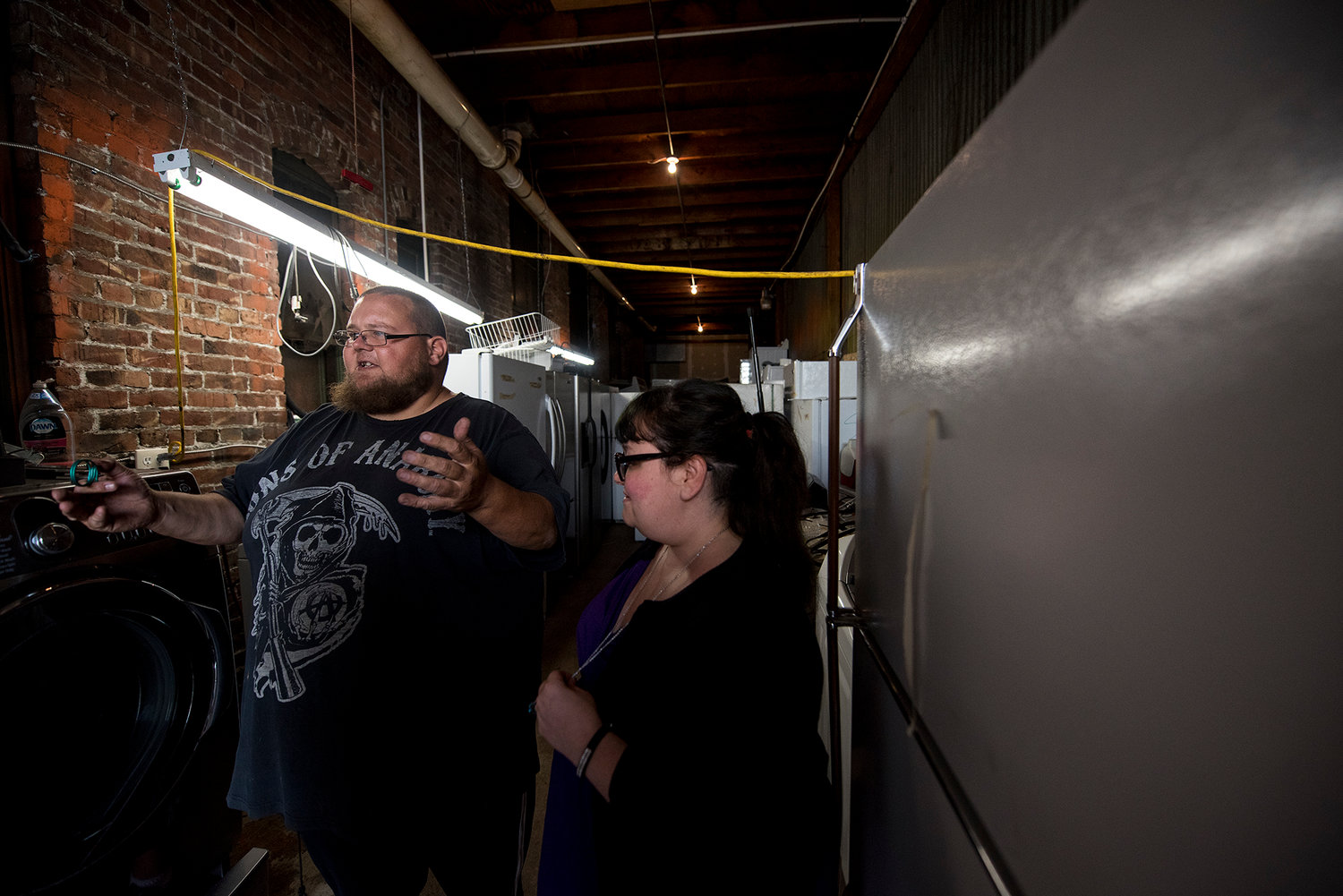 Angie Solis, who owns D.B. Cooper Appliances, and her husband, Donald Byron Cooper, who does a lions share of the maintenance and refurbishing work, show the shop area of their downtown Chehalis store.