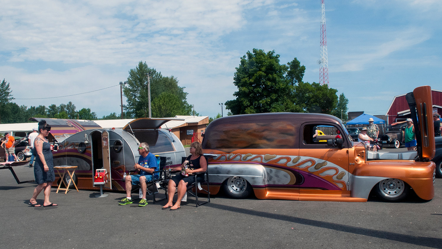 Ed and Janet Kelson, of Covington, answer questions from spectator Jennifer Walters, of Seattle, as they show off their 1948 Ford Panel van hot rod and restored 1936 Teardrop trailer at the Billetproof NorthWest car show at the Southwest Washington Fairgrounds Saturday.