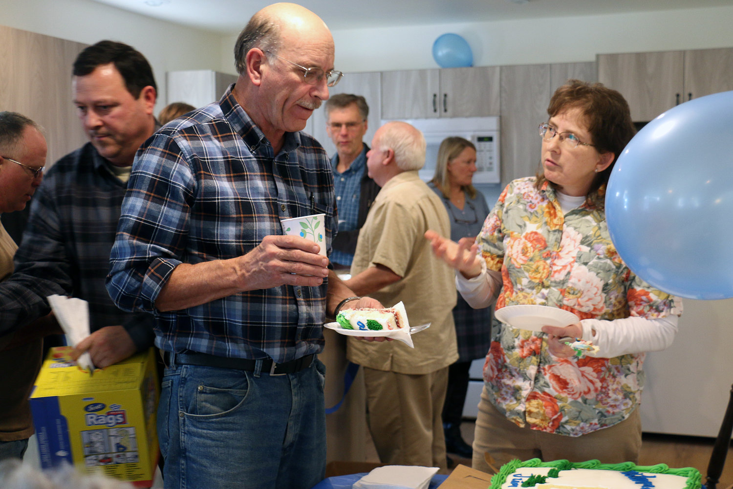 Jeanette Southmayd speaks with Greater Lewis County Habitat for Humanity’s assistant production manager Richard Tausch on Saturday. Southmayd and her husband Jim took part in the ceremony where they were awarded a new house located in Chehalis.