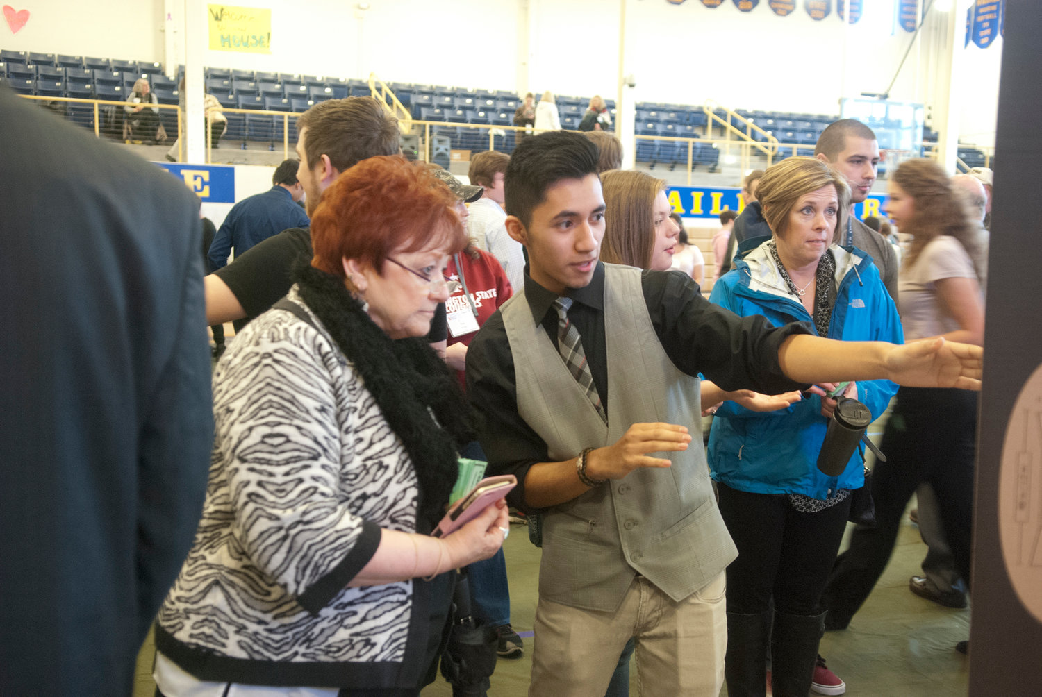 Student Omar Flores pitches his company’s product to judge Flossie Heymann, acting as a potential investor at Washington Business Week Thursday at Centralia College. The teams were in a competition to earn the most Business Week Bucks during the mock trade show.