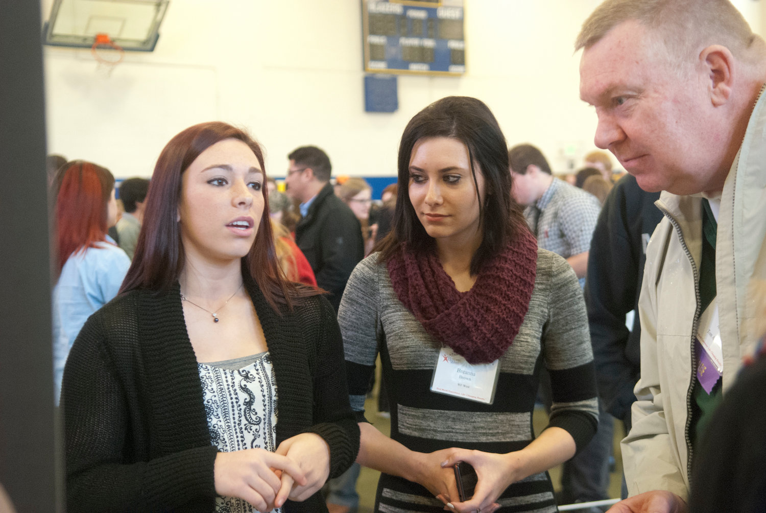 Students Kyndra Haller, left, and Breanna Brown pitch their company’s product to judge Tom Alderson, who was acting as a potential investor at the mock trade show Thursday at Washington Business Week at Centralia College. More than 400 juniors from Centralia and W.F. West high schools attended the annual four-day event.