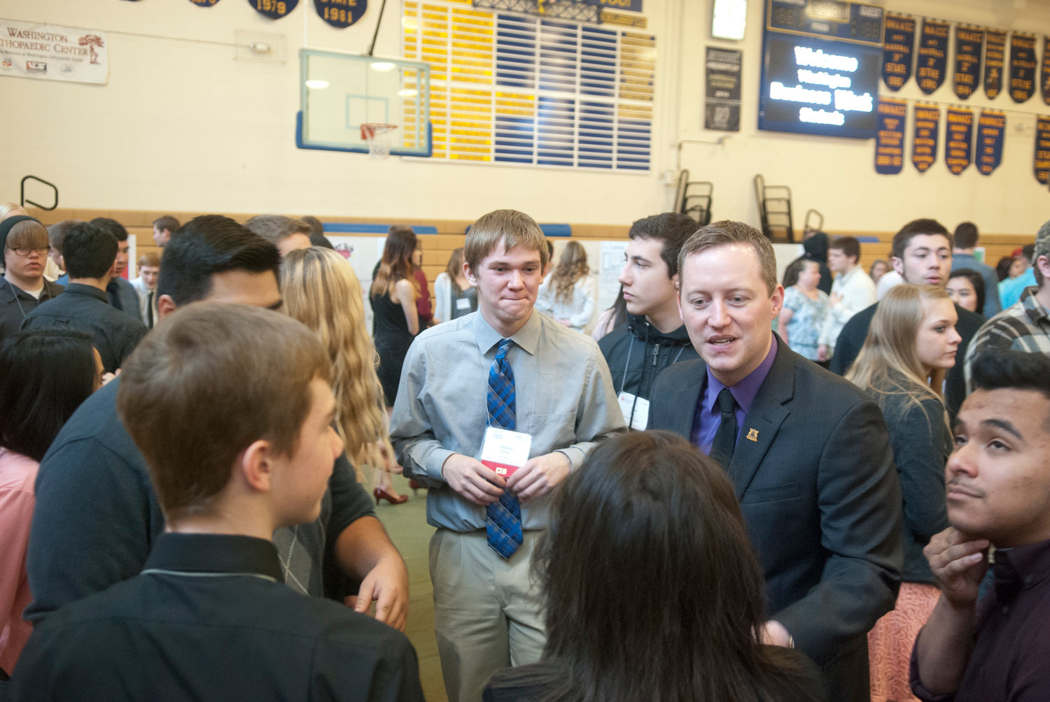Company Advisor Matthew of Express Employment Professionals gives his team a pep-talk before the trade show portion of Washington Business Week in Centralia Thursday. More than 400 juniors from W.F. West and Centralia high schools participated in the four-day event.