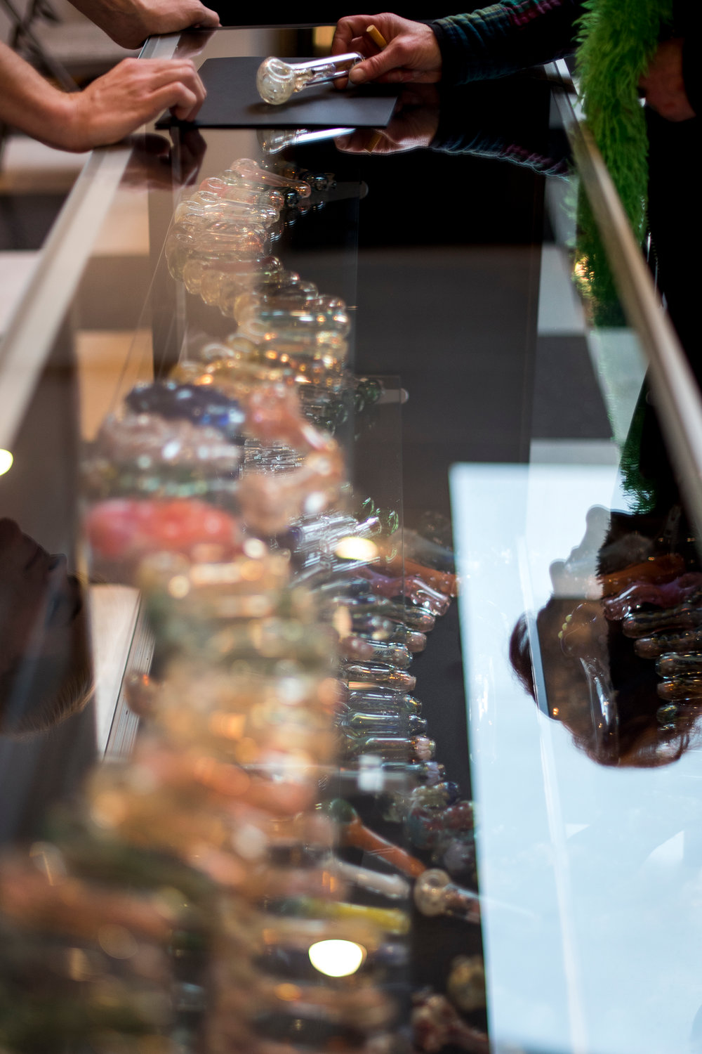 A customers looks at one of many glass pipes in a case at The Jackal in downtown Chehalis on Tuesday, Nov. 24.