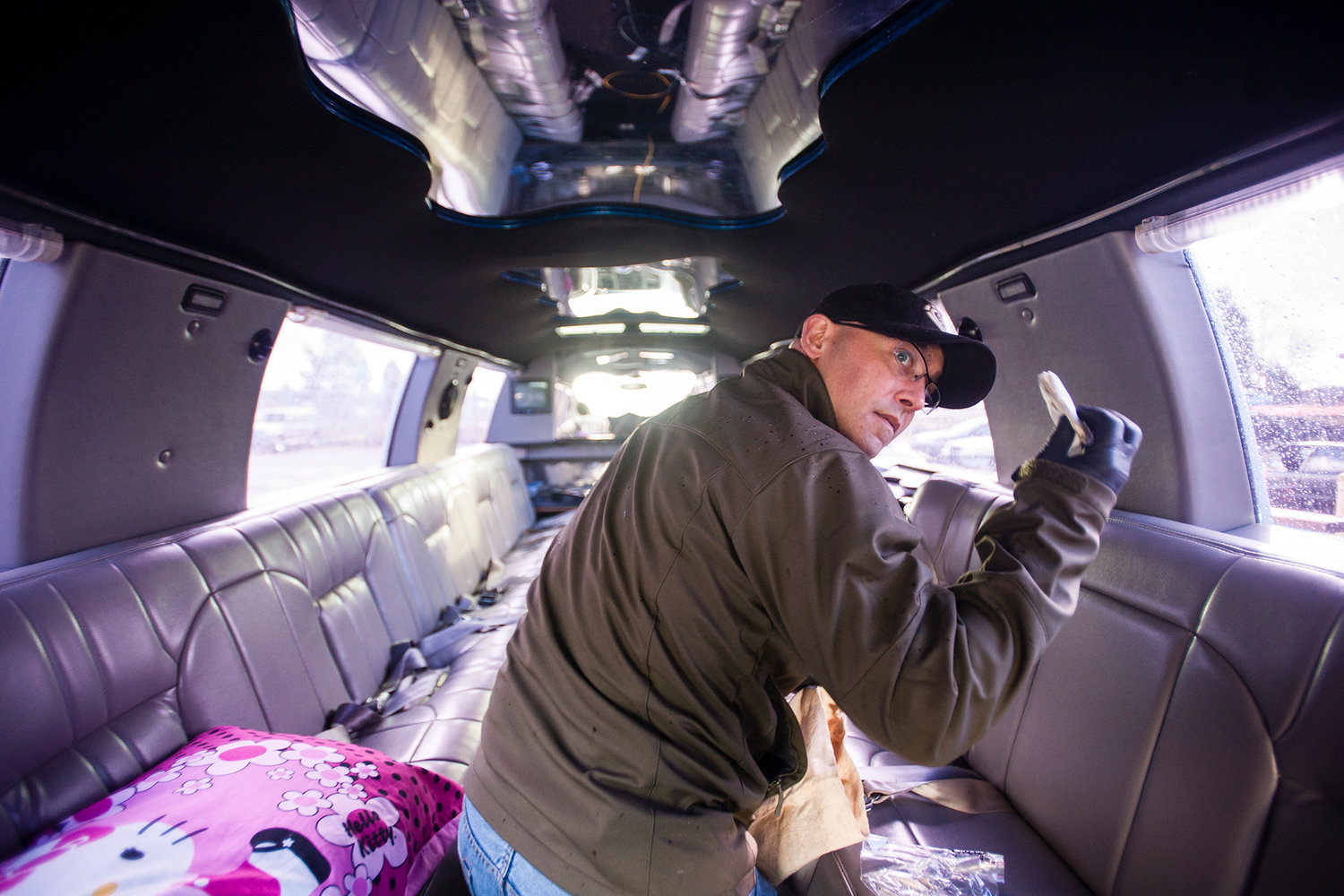 Chad Withrow, of the Centralia Police Department Anti-Crime Unit, discovers a small baggie of hash oil behind one of the seats in a limousine that the department seized on Monday, March, 10, 2014. It's an example of a seizure in which some items were later sold with the profits going back to the city. 
