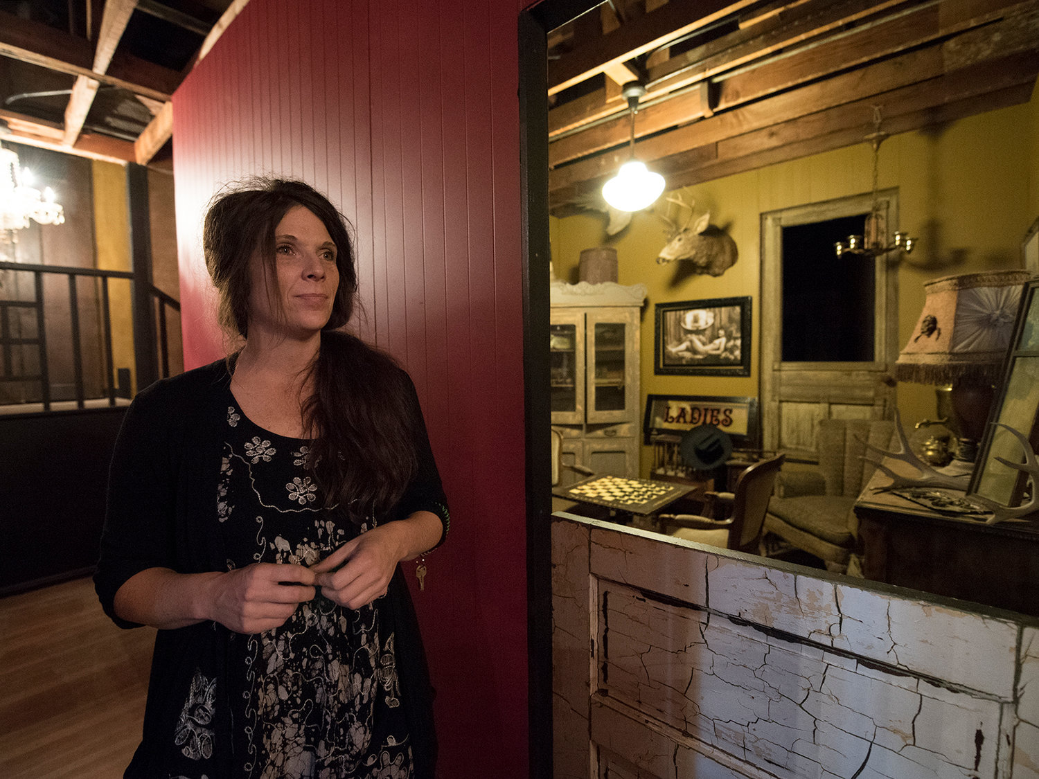 Holly Phelps, owner of the Shady Lady in downtown Centralia, stands in the narrow hallway of her new Bordello Museum. The exhibit to the left of Phelps is a recreation of a smoking room in a brothel.