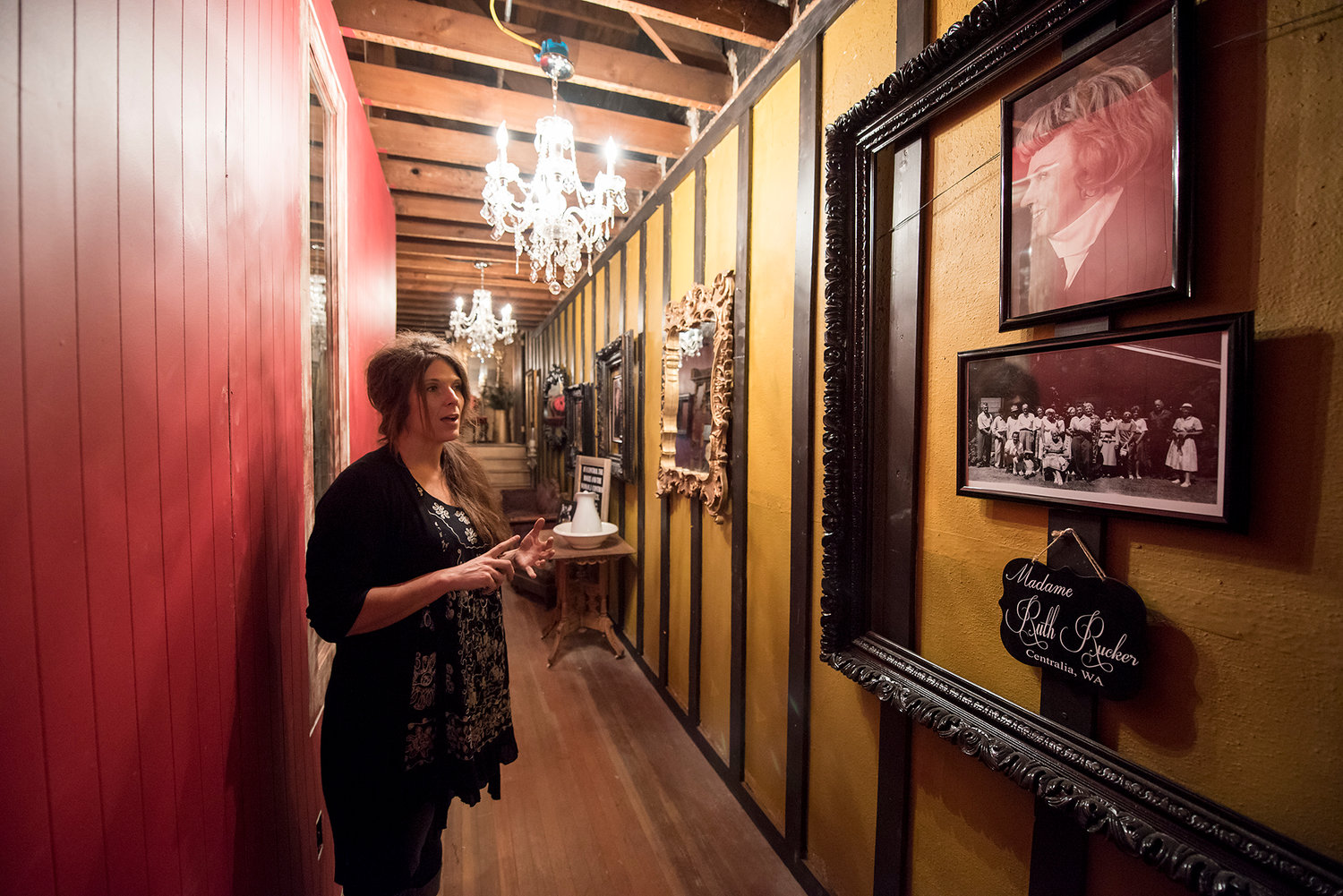 Holly Phelps, owner of the Shady Lady in downtown Centralia, stands in the narrow hallway adorned with pictures of Madame Ruth Rucker, who ran a brothel in Centralia in the early 20th century, while giving a tour of her new Bordello Museum on Wednesday afternoon. The museum, which opens on Friday, is styled after Madame Rucker's apartment and will focus on the entrepreneurship of the women who ran these brothels as businesses to support their families.