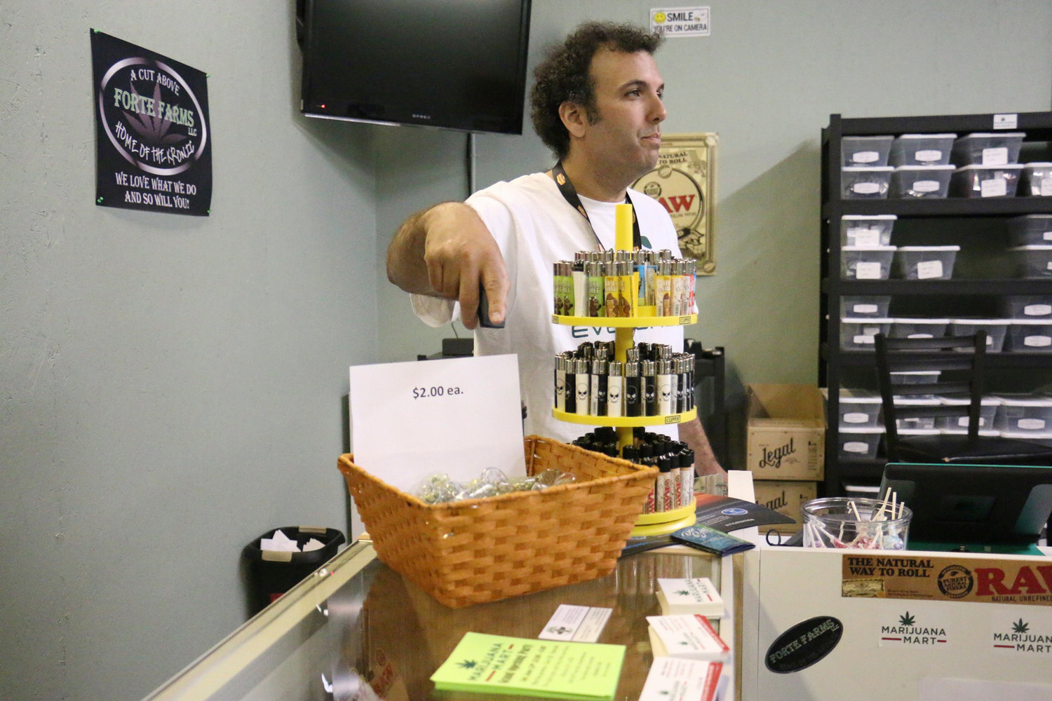 Business partner Mike Trobman points to a special on pipes at Marijuana Mart in Grand Mound. The store opened on May 27 and was the first recreational marijuana store in Grand Mound.