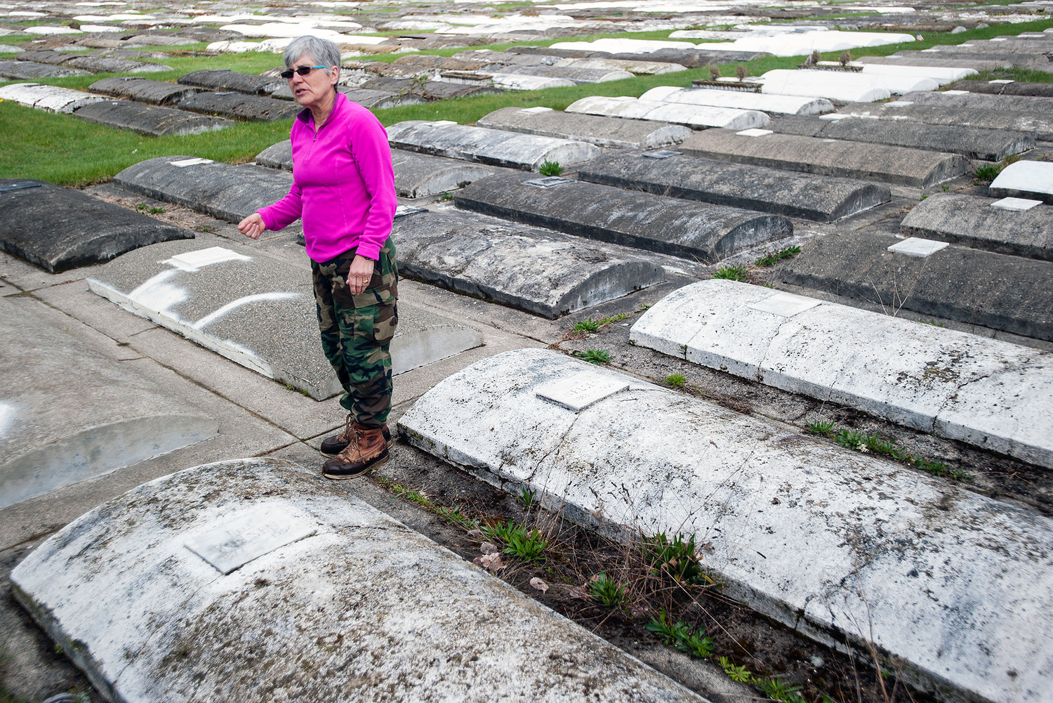 Jennifer Duncan, former caretaker at Greenwood Cemetery, stands amid rows of surface burial vaults in this photograph taken in April 2014 at the Centralia cemetery.