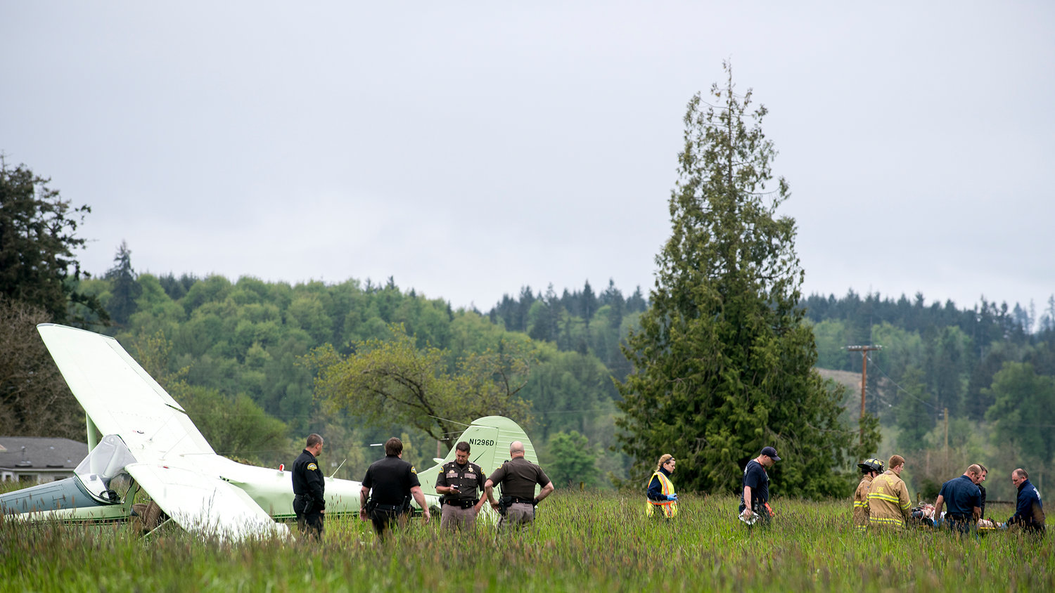 First responders remove a 73-year-old man from the plane that he crash landed in a field near Grand Mound on Tuesday afternoon.