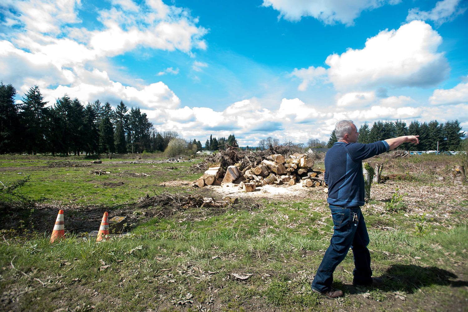 David Kois points to the towards a crop of trees that signifies the end of his property line of the land that he plans to lease for his marijuana grow facility off of Reynolds Road in Centralia on Monday afternoon.