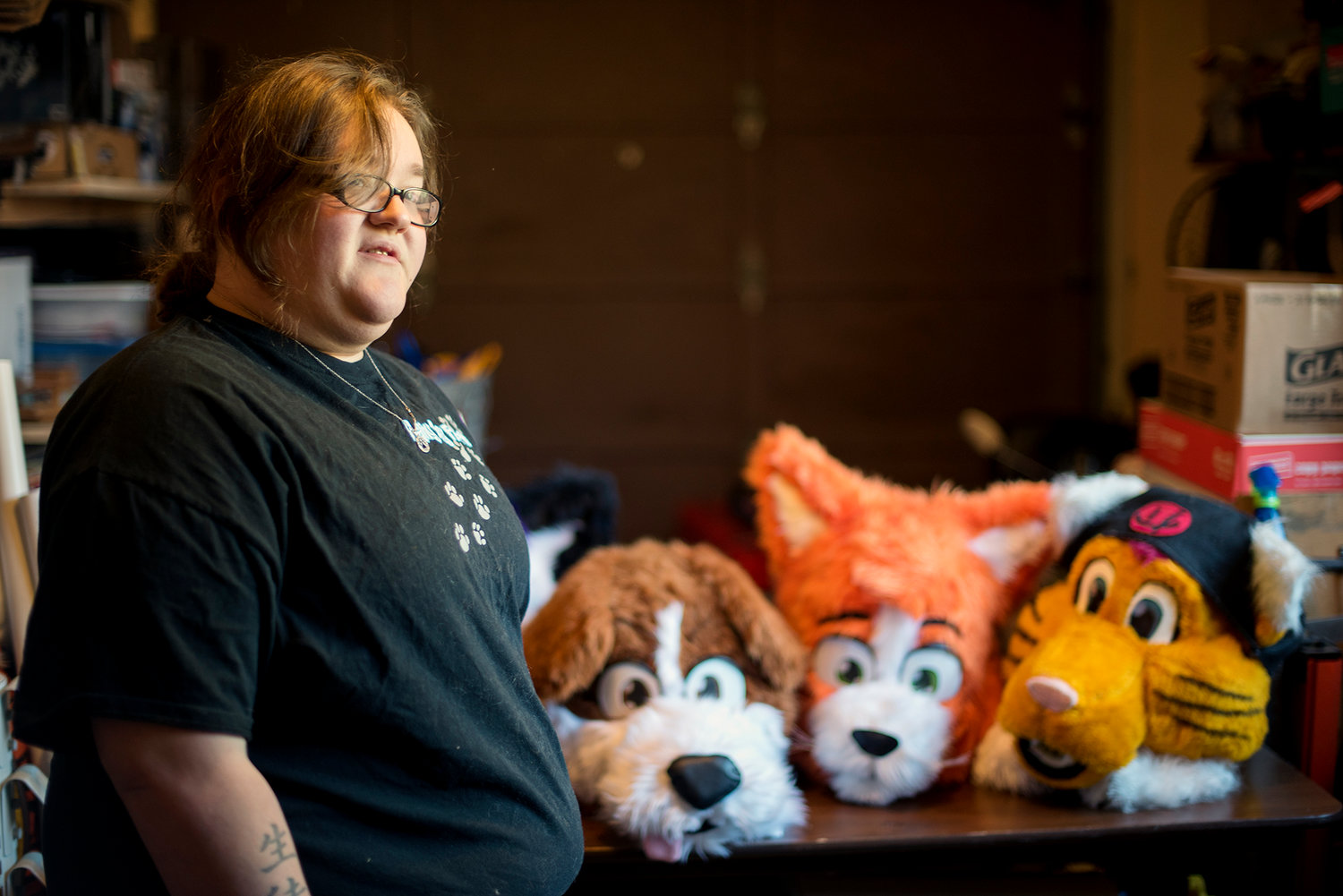 Amanda Grary stands in front of a trio of costume heads that she has designed and built from scratch at her home in Centralia on Tuesday, Nov. 11.