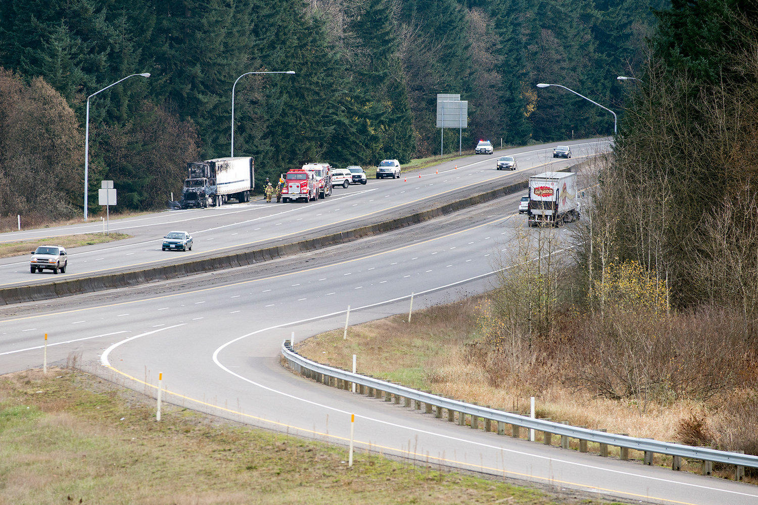 First responders attend to a semi truck that caught fire while driving north on Interstate 5 on Tuesday afternoon near exit 71 in Napavine.