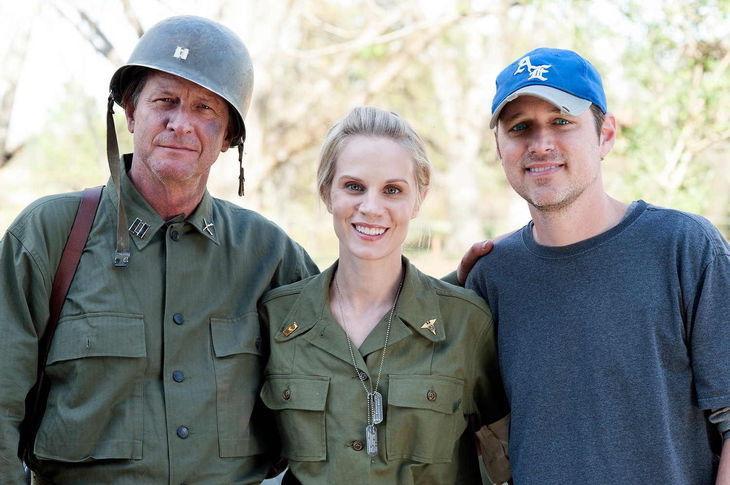 Eric Colley, right, and his wife, Hallie Shepherd, pose with actor Brett Cullen on the set of “The Last Rescue,” a film focused on events of World War II.