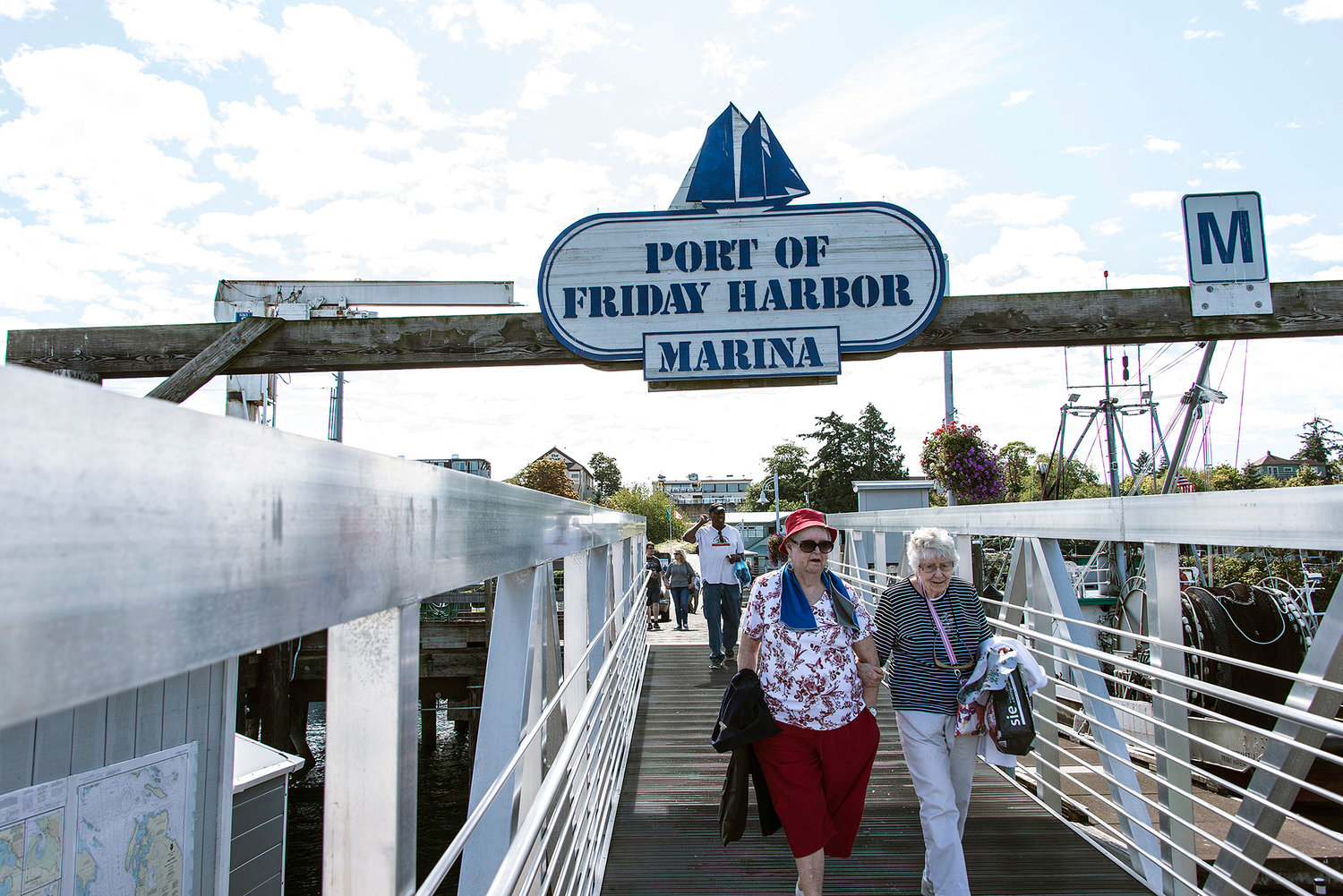 Freedom Tours NW customers walk down a walkway at Friday Harbor during a recent trip from the Winlock-based company.