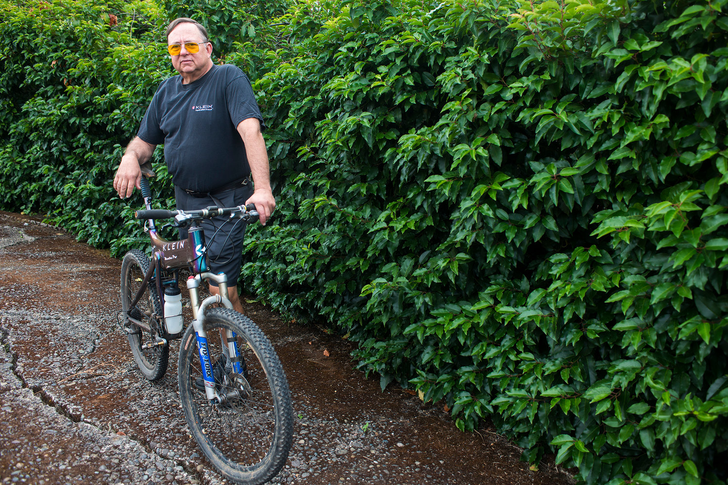 Gary Klein poses for a portrait at his house behind one of his bikes on Friday morning in Chehalis. Klein designed this particular mountain bike in 1995.
