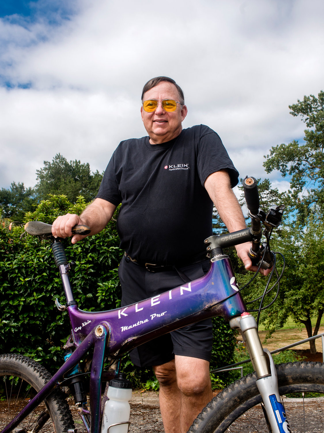 Gary Klein poses for a portrait at his house behind one of his bikes on Friday morning in Chehalis. Klein designed this particular mountain bike in 1995.