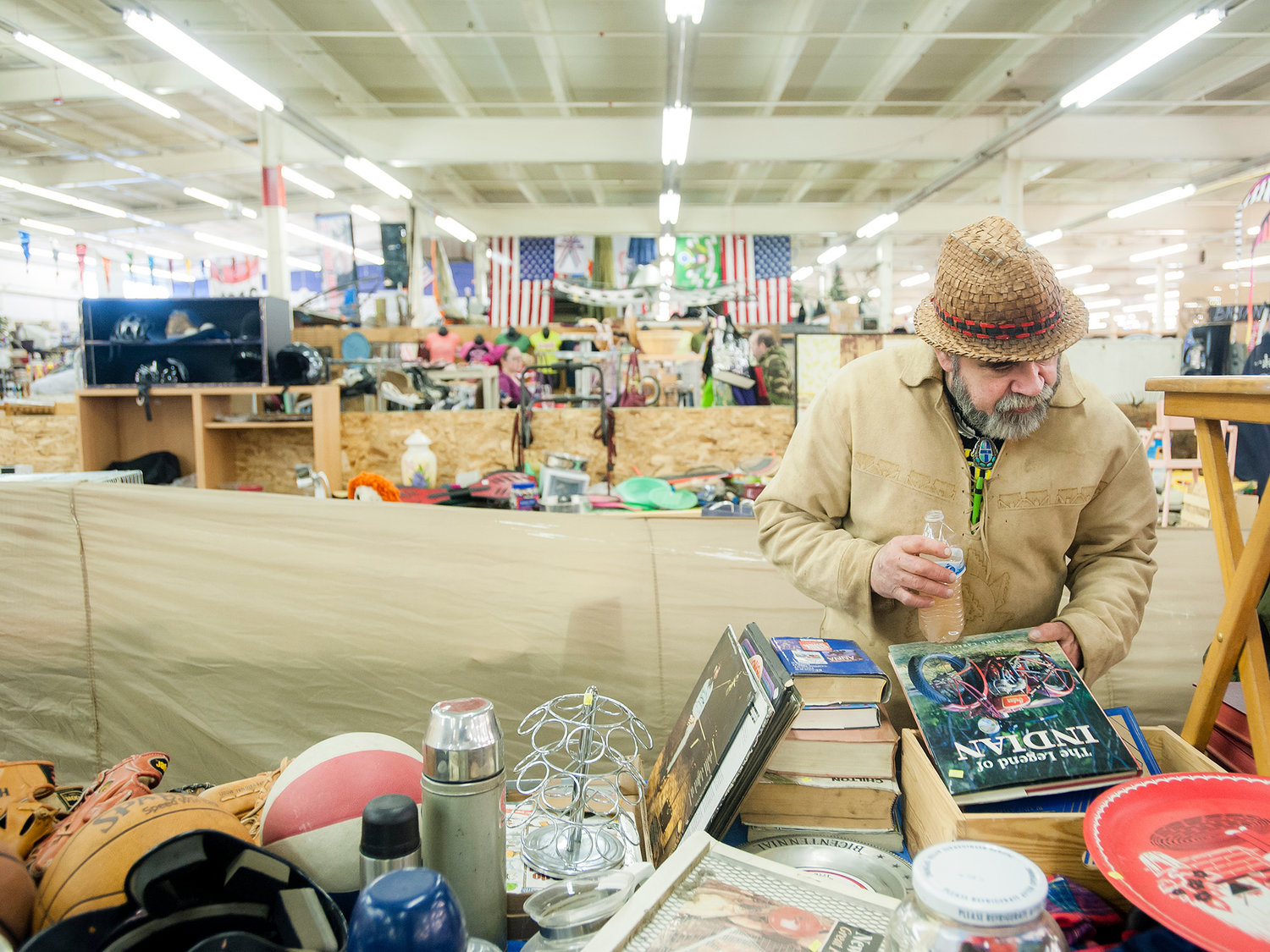 Chief Alexander sorts through books at Jerry Roper's shop at Yard Birds Mall in Chehalis on Tuesday, Feb. 25.