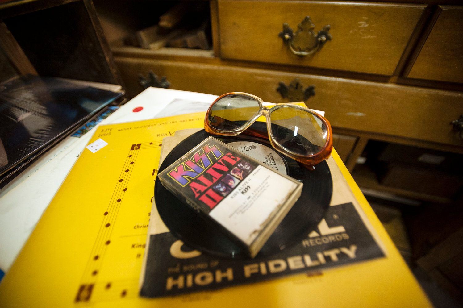 Sunglasses, a KISS cassette tape, and a couple records sit on a table at Cowlitz River Antiques on Monday, March 3, 2014 at Yard Birds in Chehalis. The items were picked out by Mat Griesse, Chehalis, who spent time looking through an amalgam of collectibles at the store on Monday.