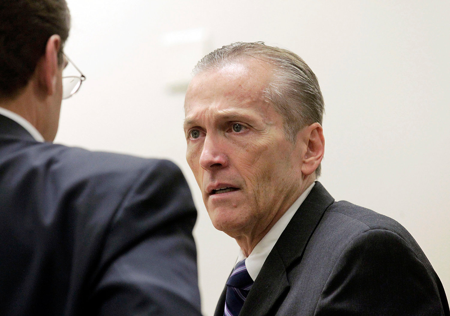 Pleasant Grove physician Martin MacNeill, charged with murder for allegedly killing his wife, Michele MacNeill in 2007, speaks with his defense lawyer Randy Spencerr, during his murder trial in Provo, Utah, Friday Nov. 1, 2013. The murder trial of the Utah doctor charged in his wife's death resumed Friday with testimony from medical experts about how they believe the 50-year-old woman died. (AP Photo/The Salt Lake Tribune, Al Hartmann, Pool)