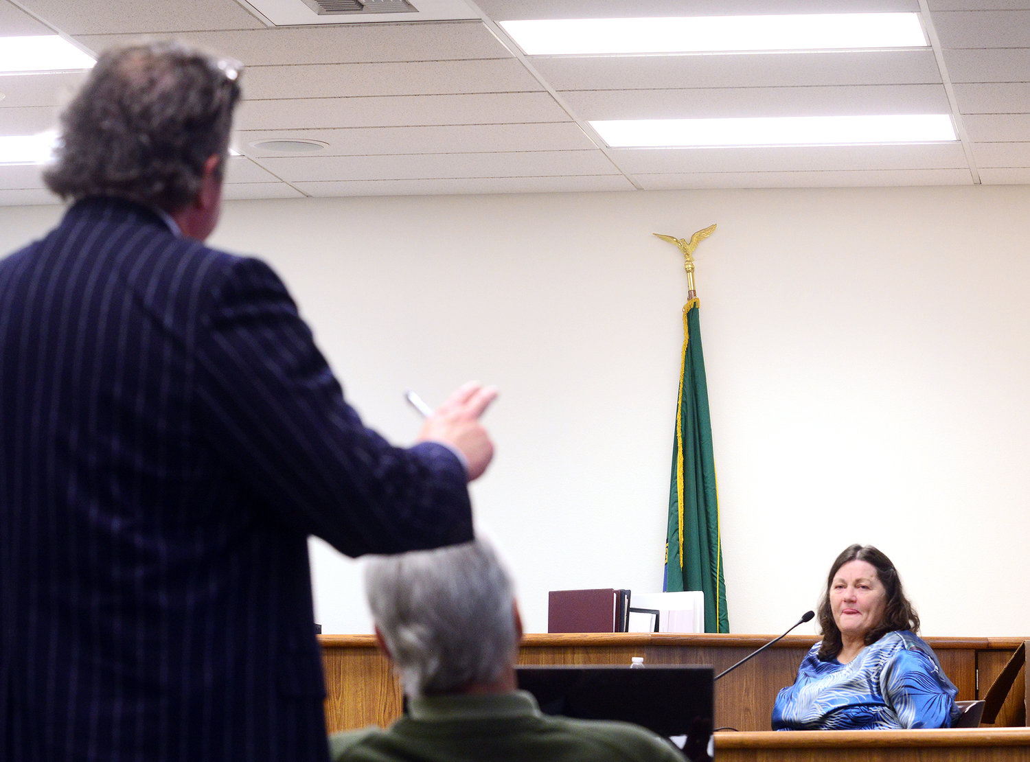 John Crowley, left, Rick Riffe's defense attorney, stands behind his client as he cross-examines Deborah George during Riffe's double-homicide trial in Lewis County Superior Court on Thursday afternoon at the Lewis County Law and Justice Center in Chehalis.