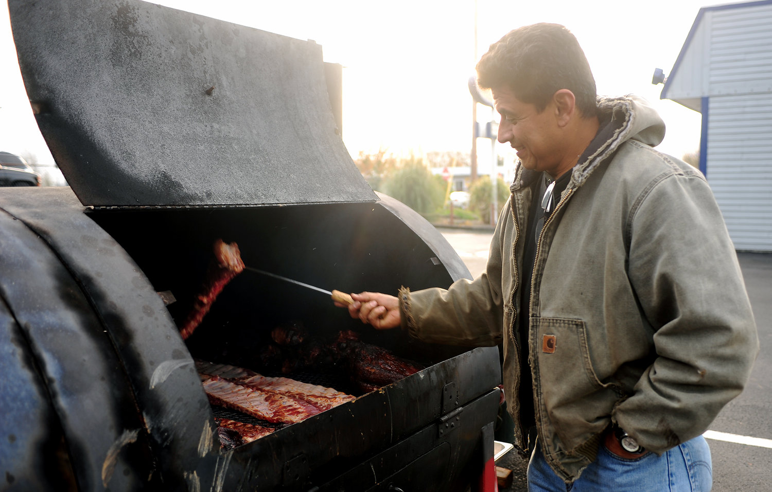 Gerado Salgado smokes meat in the parking lot of Texas BBQ Grill in Chehalis on Tuesday afternoon.