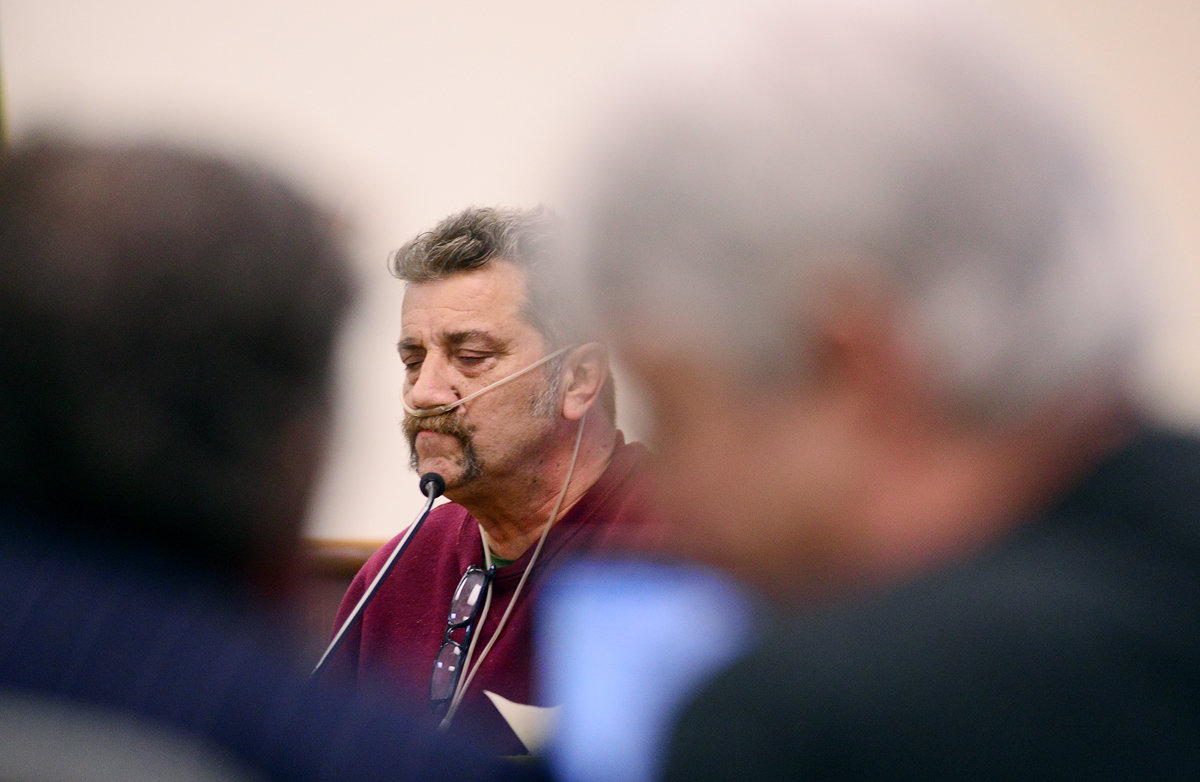 Donald Burgess, center, sits at the witness stand as Rick Riffe, right, whispers to his defense attorney, John Crowley, during Riffe's double-homicide trial in Lewis County Superior Court on Wednesday afternoon at the Lewis County Law and Justice Center in Chehalis.