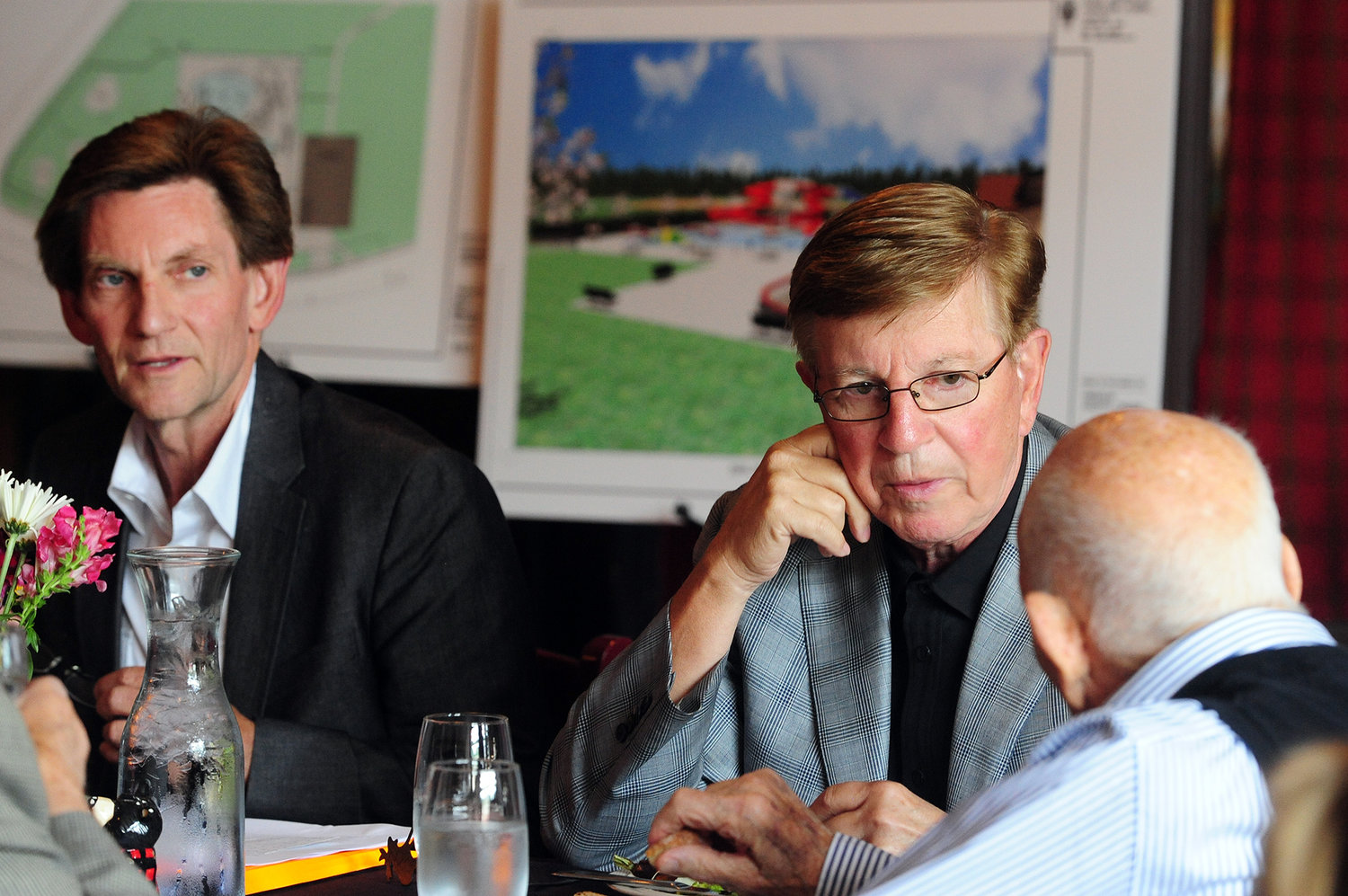 Kevin Smith, left, and his brother, Orin Smith, listen to Gail Shaw speak while at a Chehalis Foundation luncheon at Mackinaw's in Chehalis in 2013. 