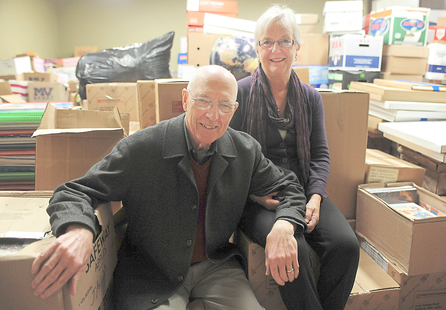 Dr. Larry Hull and his wife, Aarlie, pose for a portrait inside a unit at the Tower Plaza on Friday in Centralia. The Centralia couple have collected thousands of books which they send to libraries in developing countries such as Papua New Guinea. In honor of their years of humanitarian service, the Hulls are being given this year's Evergreen Award.