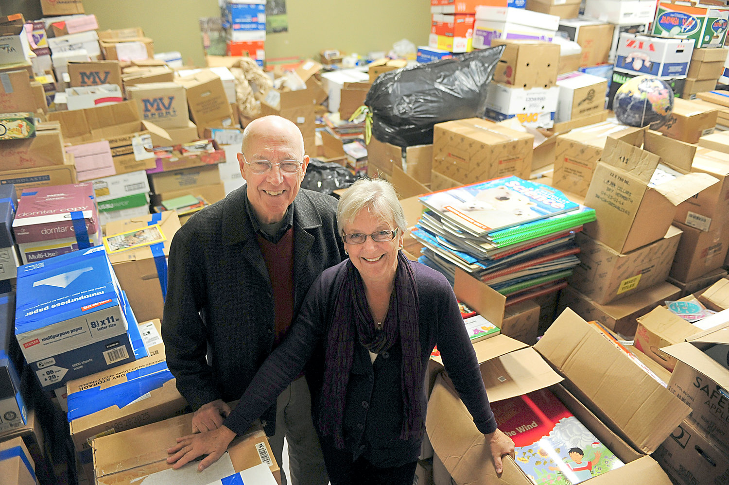 Dr. Larry Hull and his wife, Aarlie, pose for a portrait inside a unit at the Tower Plaza on Friday in Centralia. The Centralia couple have collected thousands of books which they send to libraries in developing countries such as Papua New Guinea. In honor of their years of humanitarian service, the Hulls are being given this year's Evergreen Award.