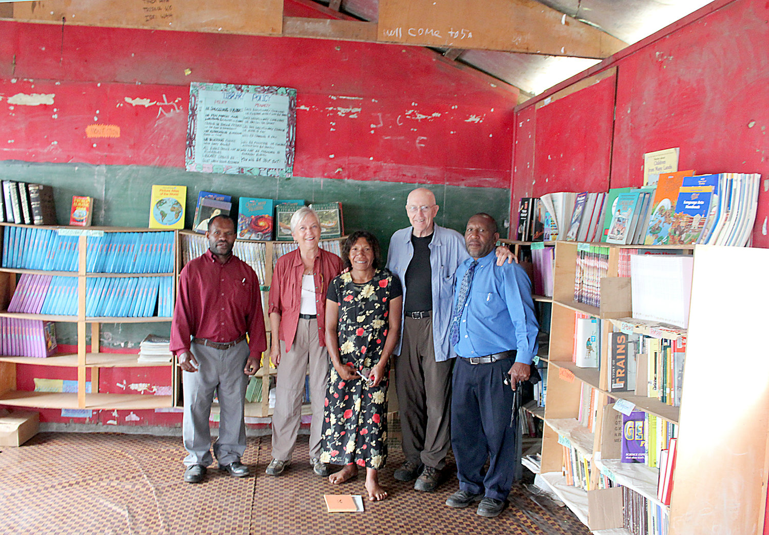 Larry and Aarlie Hull stand in a library building with local teachers at the Avi School nearby the Hull's coffee plantation in Papua New Guinea in October 2012. The Hulls collect books from their home base in Centralia and stock libraries around the world with our area's castoff texts.