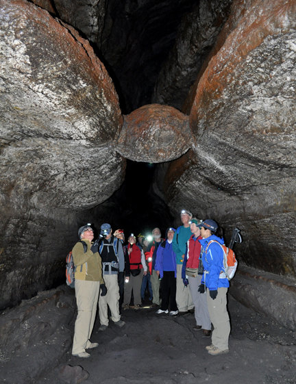 The famous “meatball” hangs over the heads of the Mount St.
Helens Institute field seminar students on Saturday. The meatball
is a block of cooled lava which fell from the lava tube ceiling
while lava was still flowing through the cave. The meatball floated
on the surface of the lava flow it was carried downstream until it
became wedged in a narrow spot above the cave floor.