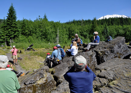 Dr. Charlene Montierth uses a mound of 2,000-year-old lava flow
for her classroom seating in the Mount St. Helens Institute field
seminar, “Lava Tubes Below: the Geology of the Ape Cave of Mount
St. Helens,” on Saturday.