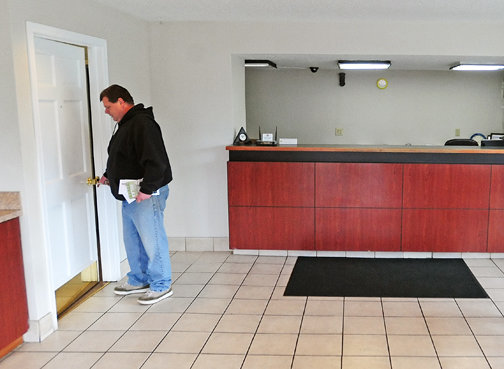 Dave Langley unlocks a door in the lobby of the Rodeway Inn in Centralia Monday. Langley represents the new owners of the out-of-business hotel. “Obviously, they didn’t know how to run a business,” he said of the previous ownership.