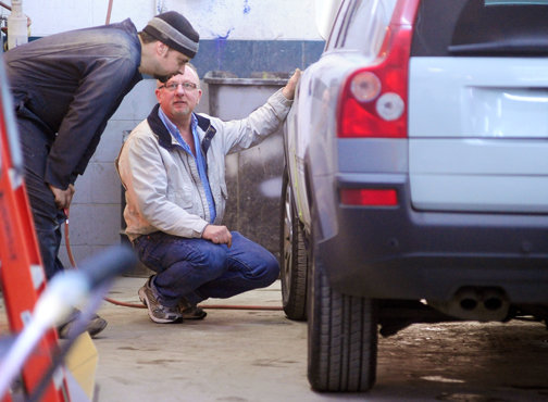 Kelly Lyons, right, talks with Josh Stone about a car at Kelly’s Auto Body in Centralia Wednesday. Lyons started Kelly’s Auto Body 30 years ago Friday.