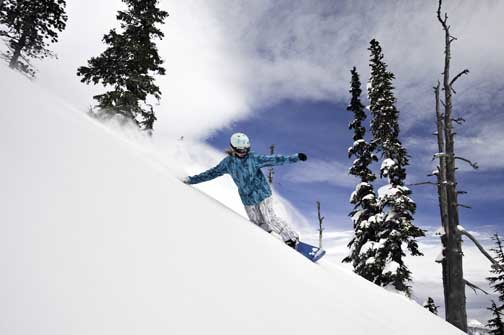 Carrie Uren, a White Pass High School graduate, carves at the White Pass Ski Resort in February. Uren is currently competing in the snowboardcross World Cup in Europe, and is one of the top 30 boardercross athletes in the world.